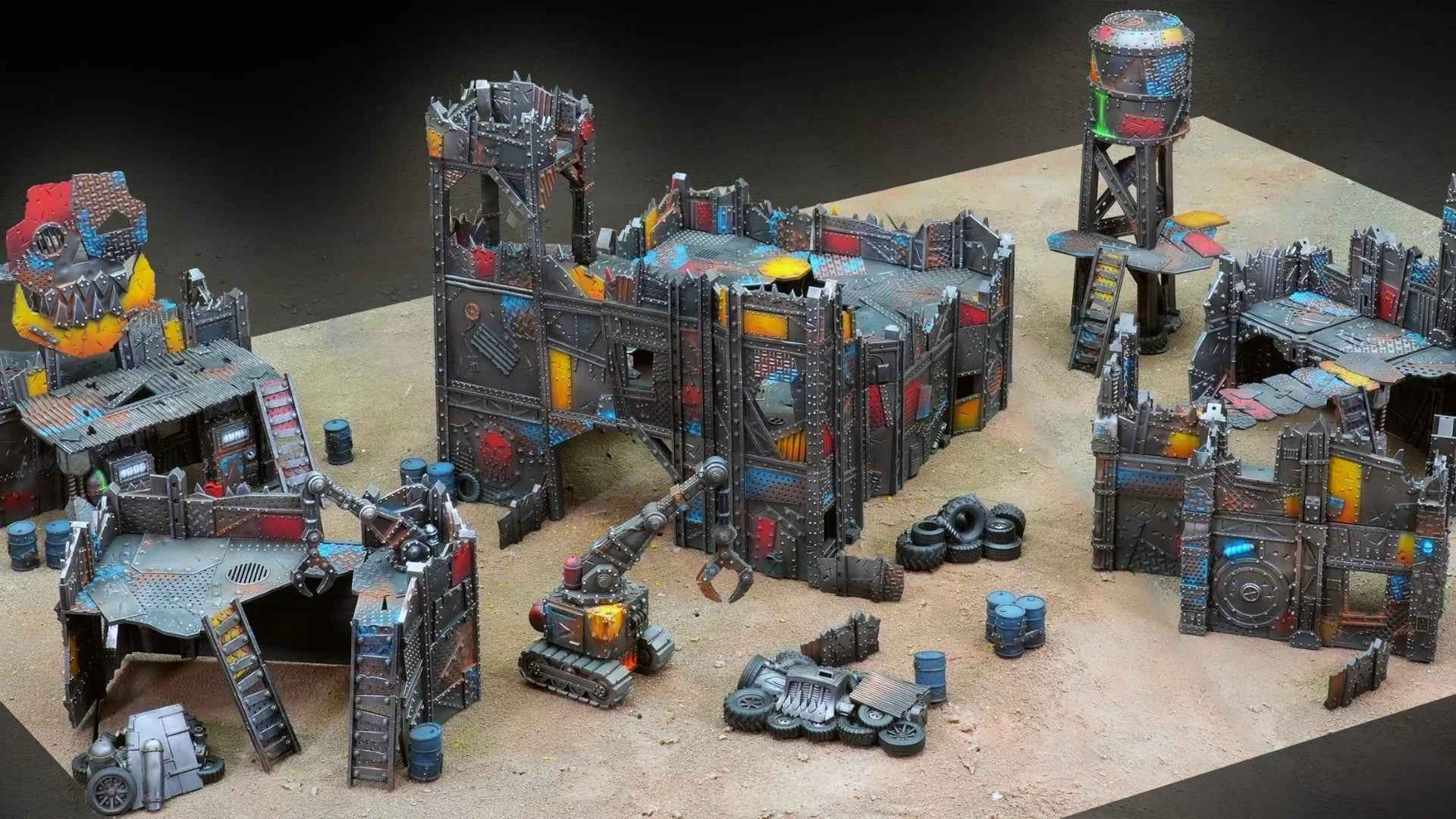 Décors wargame imprimés 3D style post-apocalyptique, bâtiments métalliques et accessoires.